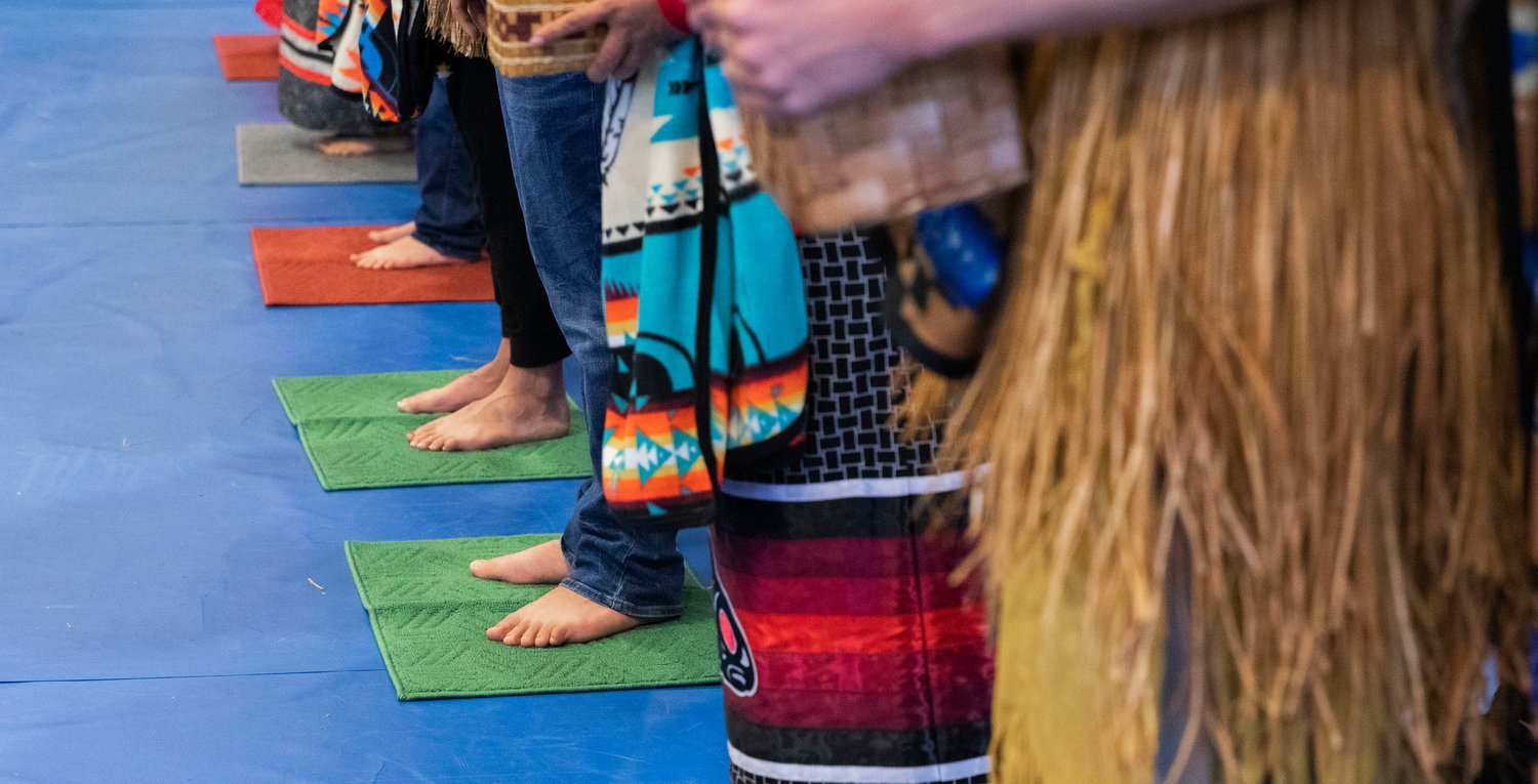 New master weavers and gatherers stand on mats, representing somewhere no individual has ever stood, during a ceremony honoring the Hazel Pete legacy at the Chehalis Tribe Community Center in Oakville on Saturday.