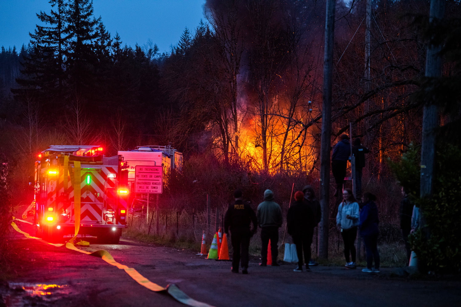 Riverside Fire Authority, Centralia Police and Chehalis Fire respond to a scene at the end of Eckerson Road in Centralia near Blakeslee Junction where flames and a column of smoke rose from a structure inside a homeless encampment Tuesday, March 28, 2023.