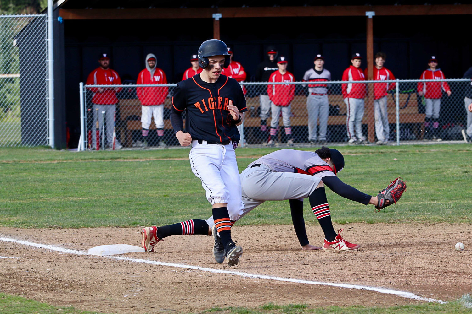 Napavine catcher Ashton Demarest reaches first after Wahkiakum's first baseman can't snag a throw for an out March 30.