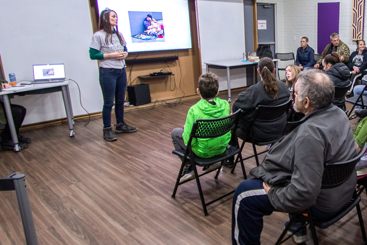 Lisa Striedinger, certifited peer specialist for the nonprofit organization Friends Without Homes, talks with attendees of a forum about the "myths and facts of homelessness" last April.