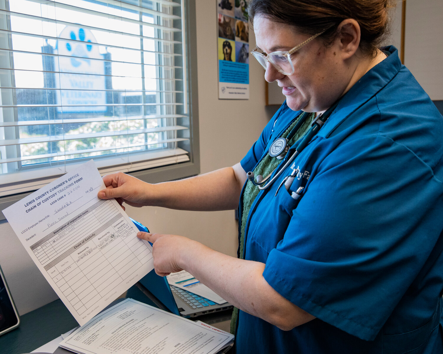 Dr. Brandy Fay shows the chain of custody form provided to her by the Lewis County Sheriff’s Office pertaining to the body of Buzzo the dog during an interview in her office in Chehalis on Saturday, April 29.