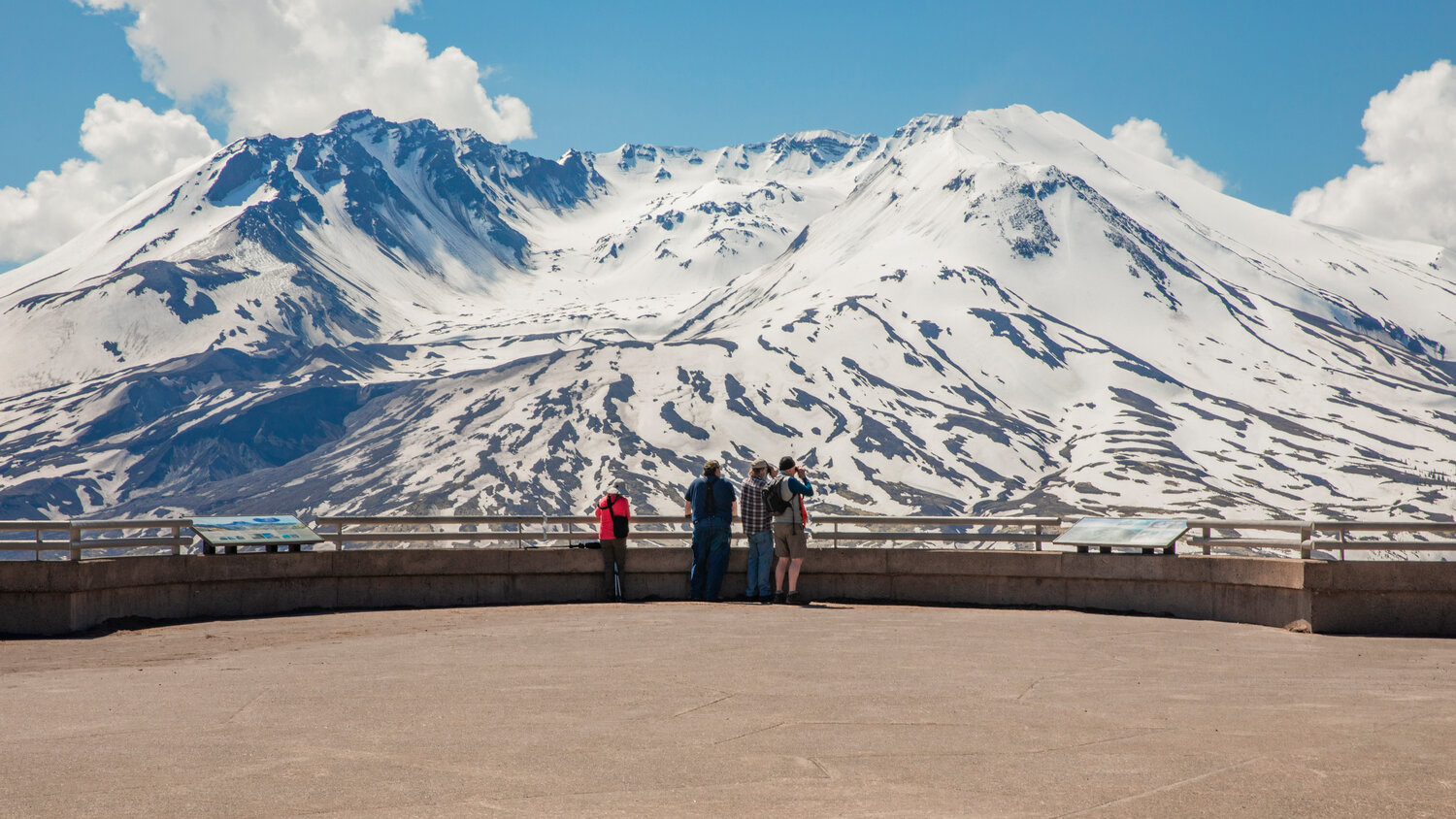 Visitors use binoculars to spot animals below Mount St. Helens from Johnston Ridge on Thursday, May 11.