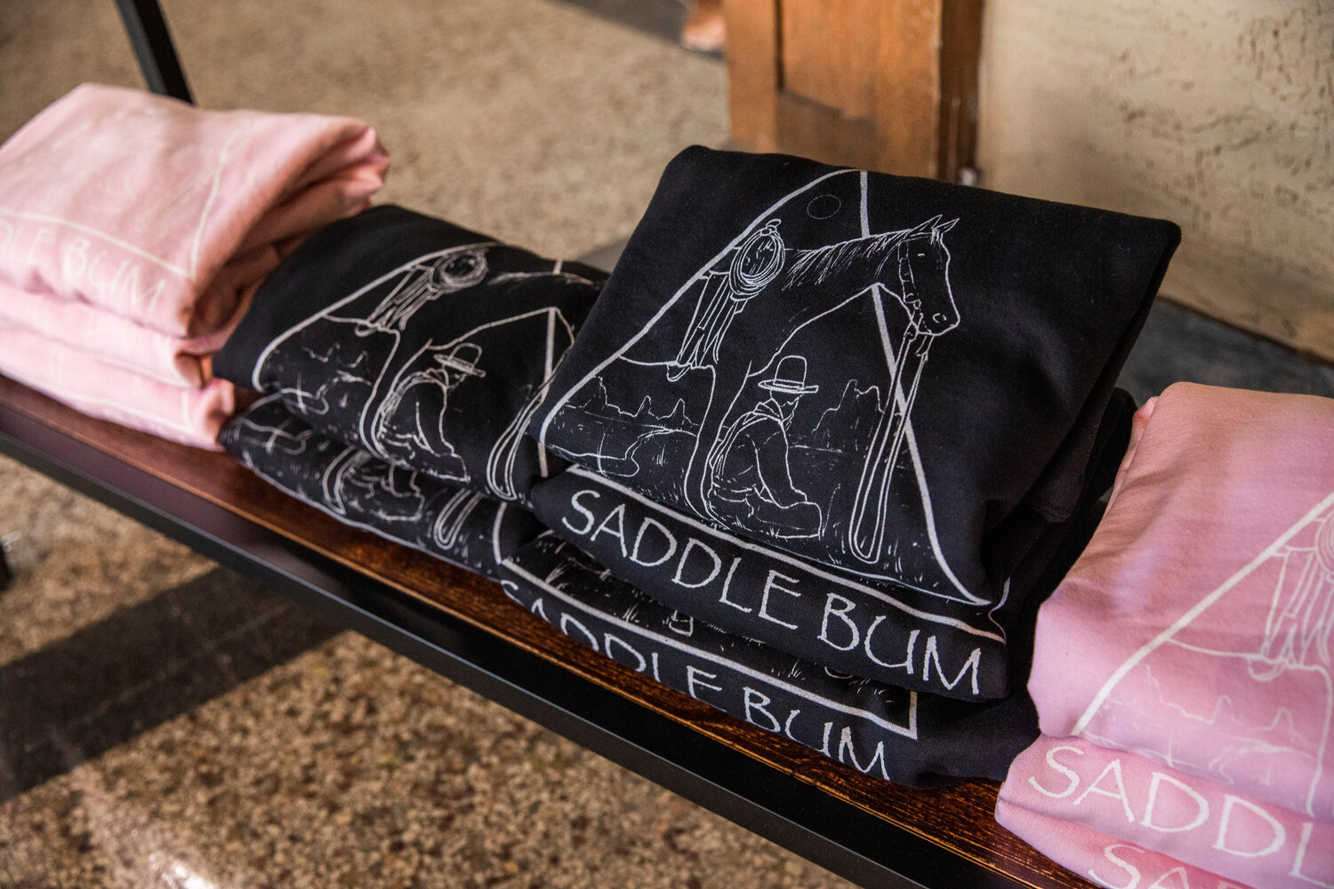 The Saddle Bum logo is displayed on hoodies in downtown Centralia on Monday, May 8.