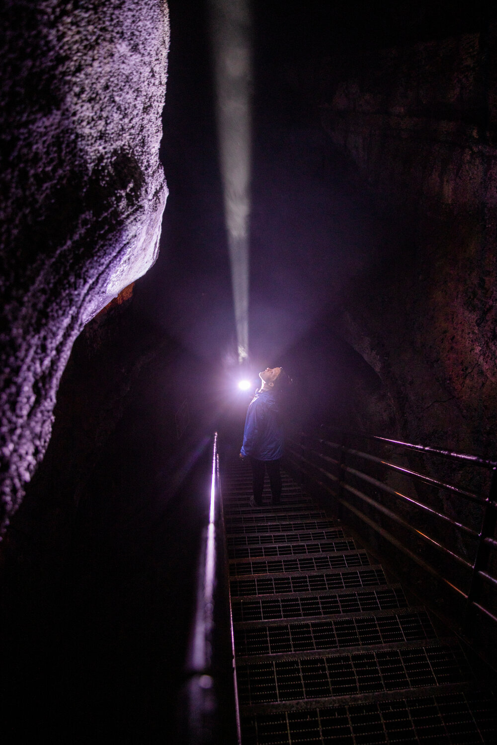 Assistant Editor Isabel Vander Stoep uses a flashlight while traveling 50 feet down to the cave floor at the Ape Cave in Cougar on opening day Thursday, May 18.
