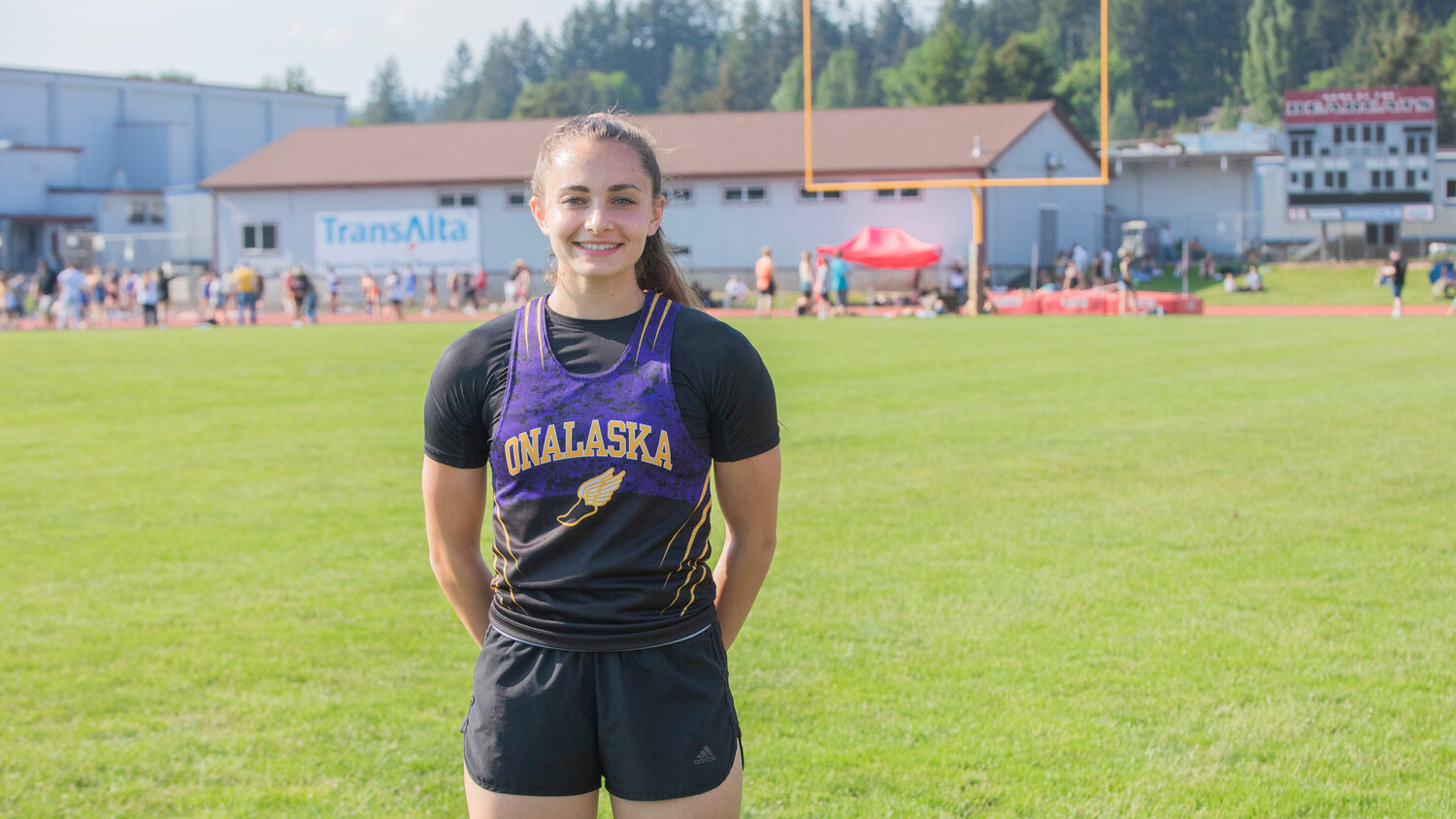 Brooklyn Sandrindge smiles for a photo in Chehalis while sporting her Onalaska Logger track and field gear Friday, May 19.