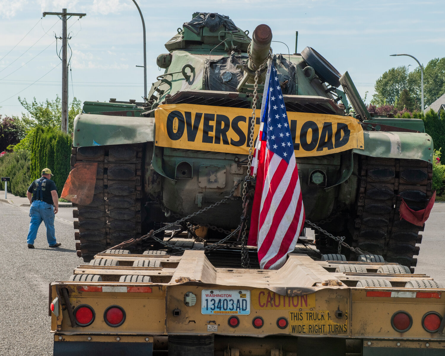 A flag hangs from a M60 tank as it is hauled into the parking lot of the Veterans Memorial Museum in Chehalis on Saturday, May 20.