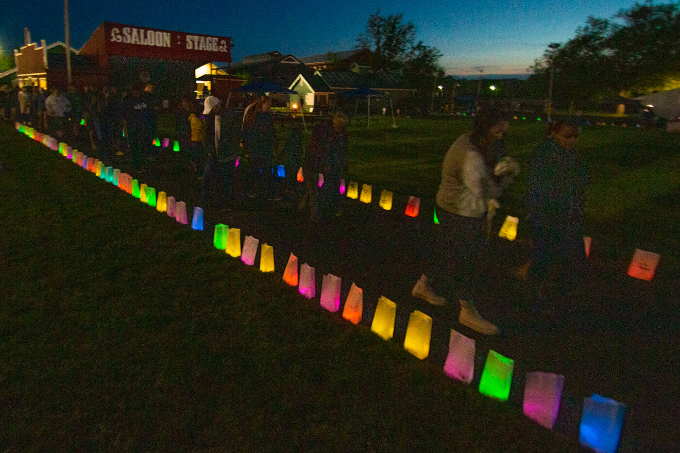 Relay for Life attendees begin the final event of the night at the American Cancer Society's Relay for Life, the luminaria walk. Each luminaria was dedicated to the honor or memory of a loved one.