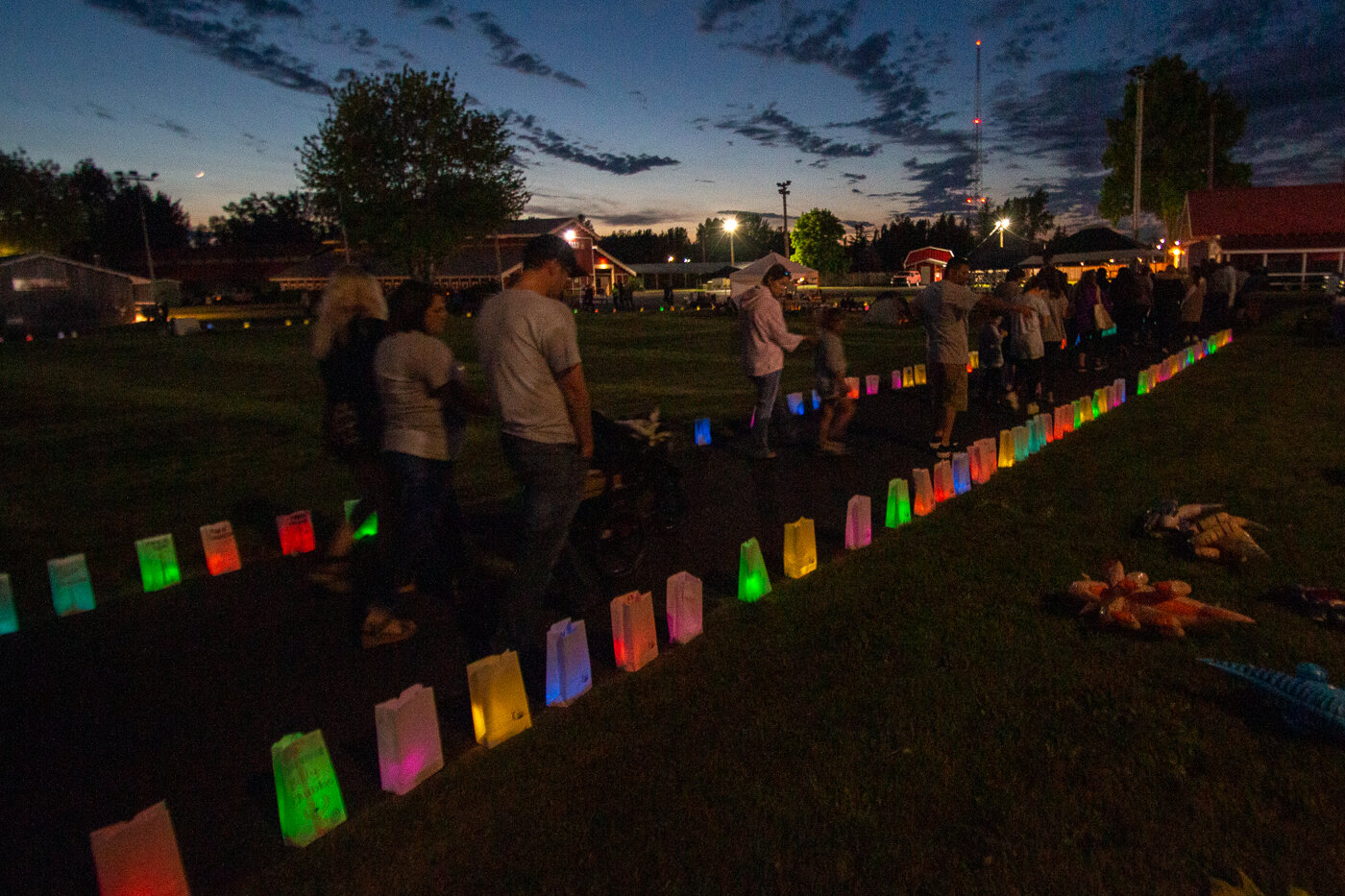 Relay for Life attendees begin the final event of the night at the American Cancer Society's Relay for Life, the luminaria walk. The names of those who lost their lives to cancer, those who survived as well as some still currently fighting were on the Luminaria.