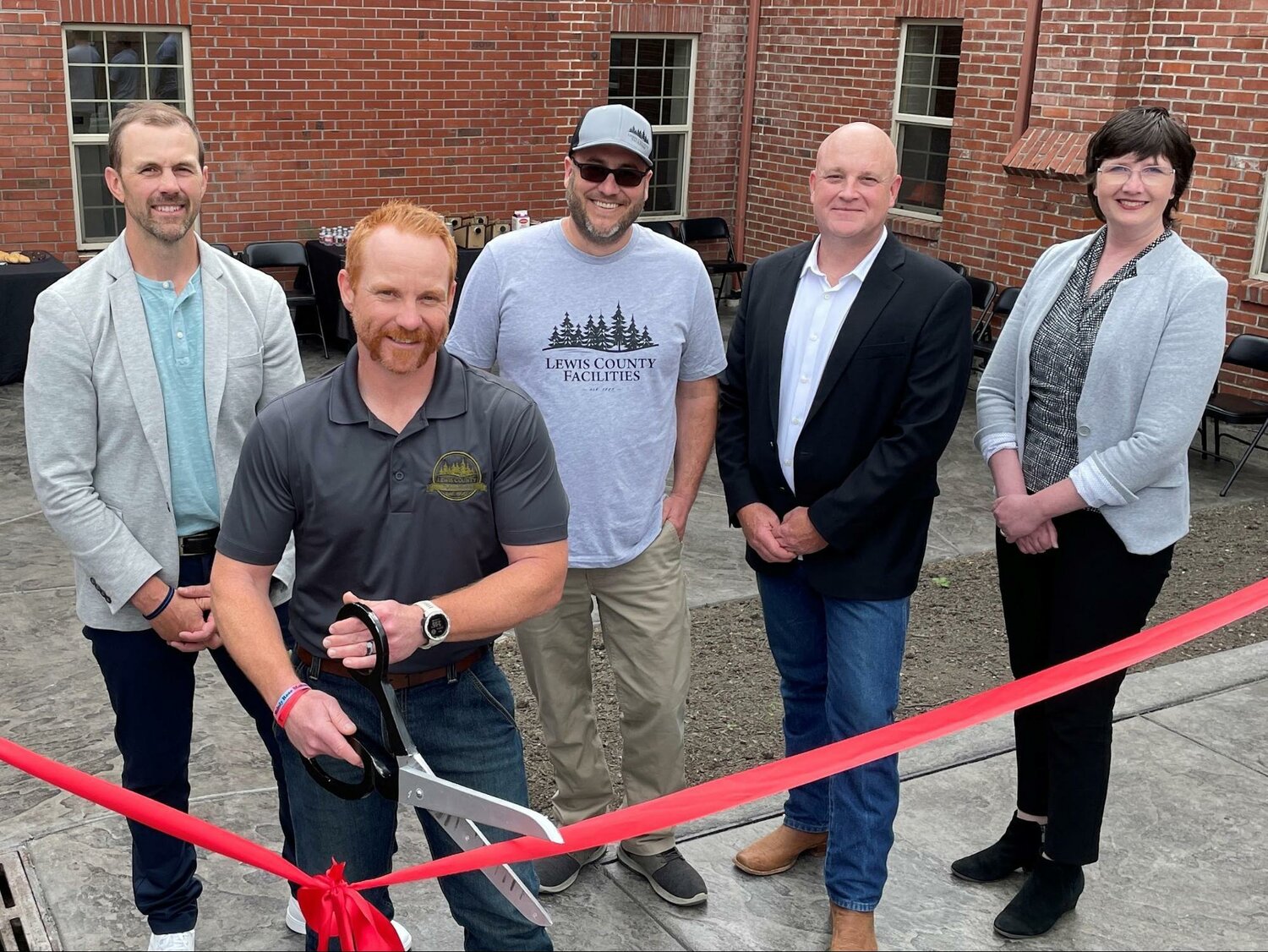 From left, Lewis County Commissioner Sean Swope, Public Works Director Josh Metcalf, Facilities Administrator Alex Murray, Commissioner Scott Brummer and Commissioner Lindsey Pollock attend the Lewis County Public Works building ribbon-cutting May 22.