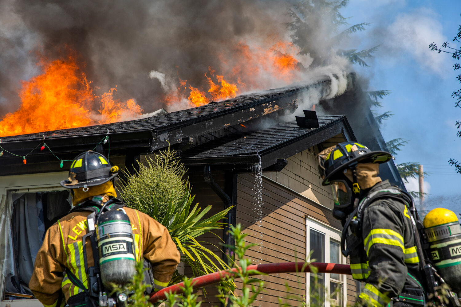 Riverside Fire Authority responds to a scene as flames engulf a structure and a column of smoke rises from a residence in the 800 block of Centralia College Blvd. on Wednesday, May 24.