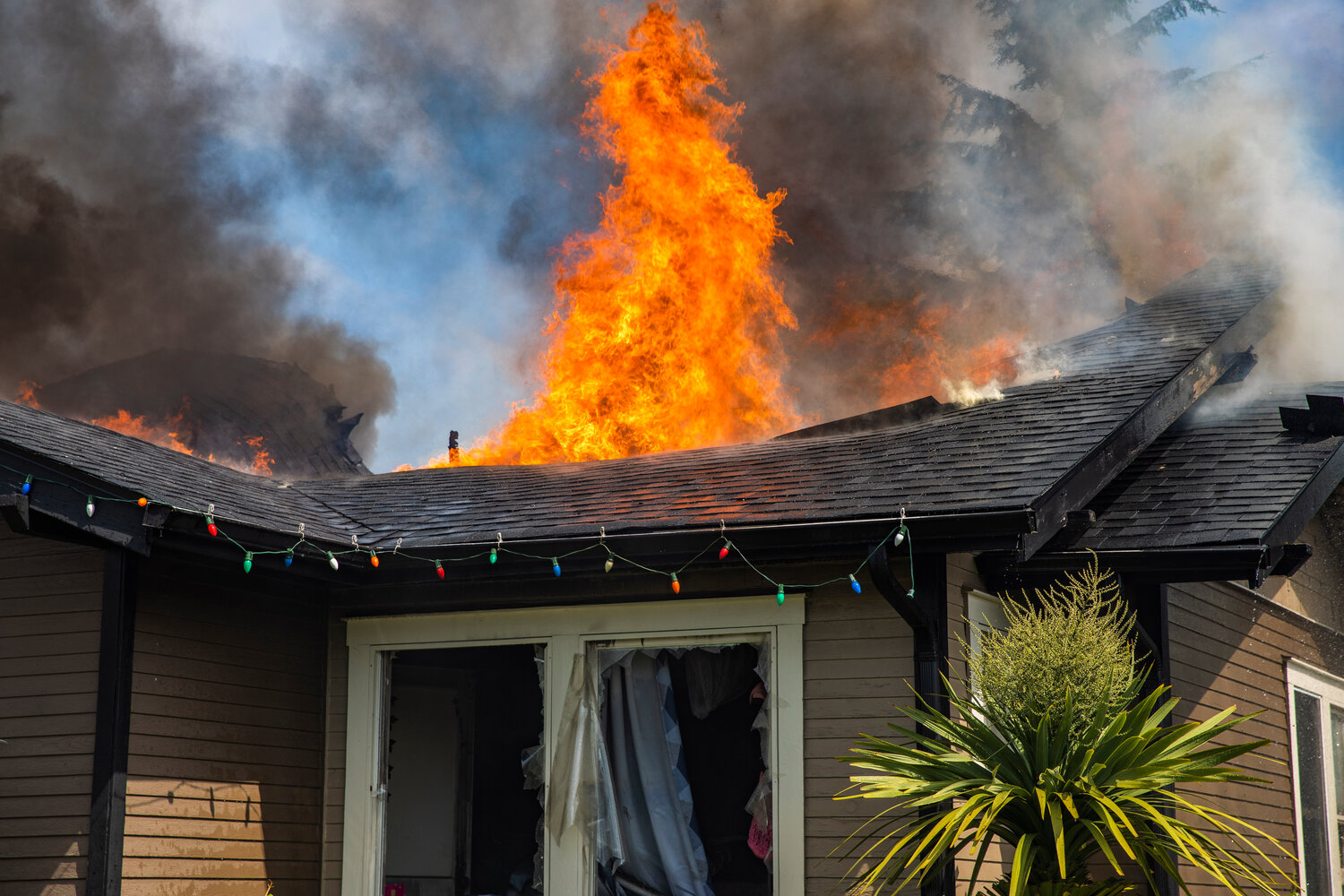 A column of flames rises from the roof of a residence in the 800 block of Centralia College Blvd. on Wednesday, May 24.