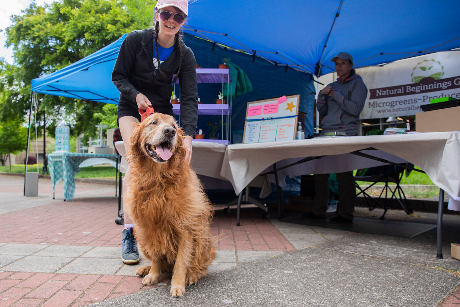 Kaelin Young smiles next to her dog Rondo during Spring Fest at Centralia College on Tuesday, May 23.