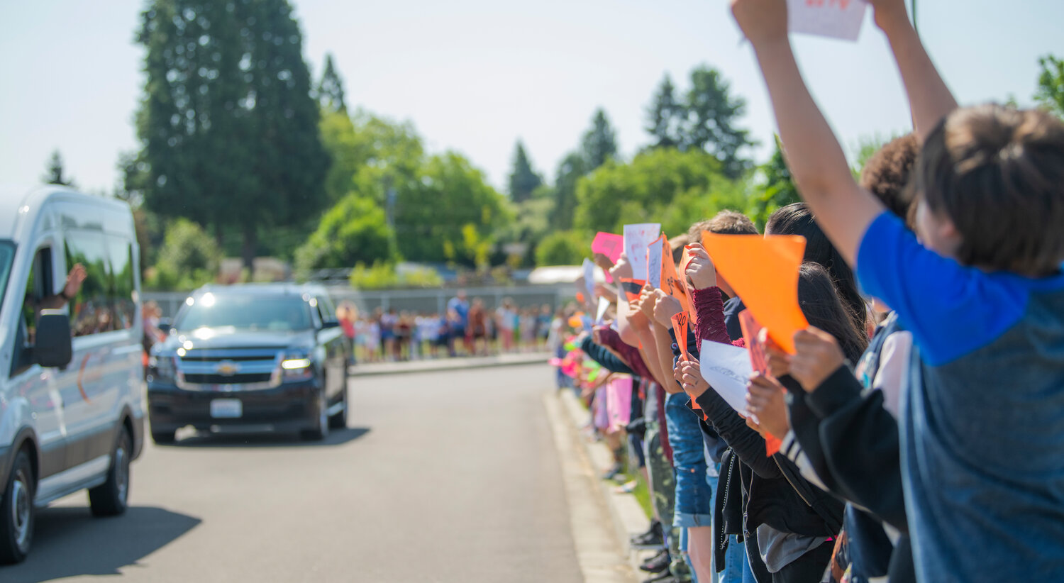 Centralia High School’s state-bound softball team parades through the parking lot of Fords Prairie Elementary and is greeted by signs and cheering on Thursday.