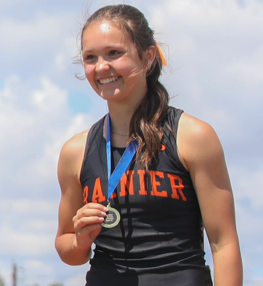 Rainier's Ella Marvin smiles atop the podium after winning the state title in the girls pole vault at the 2B state track and field championships, May 26 in Yakima.