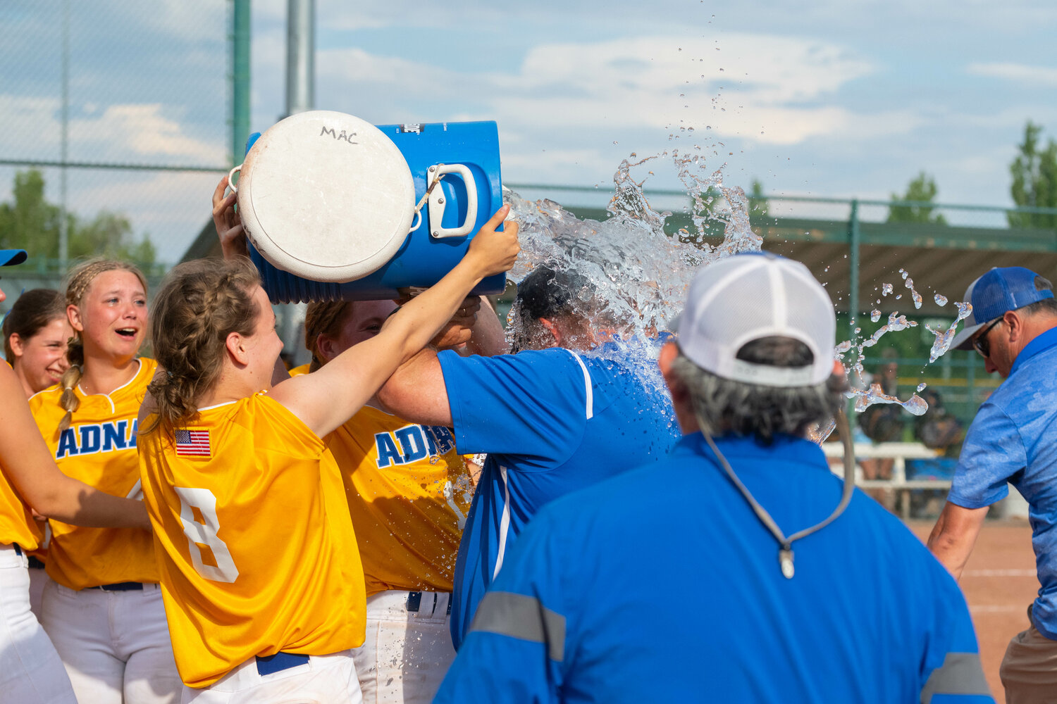 Adna players get coach Bruce Pocklington with the water bath after their 12-3 win over Forks in the 2B state title game, May 27 in Yakima.