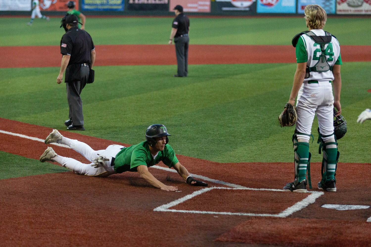 Tumwater's Andrew Collins slides home for the game-winning run against Lynden in the 2A state title game at Joe Martin Stadium in Bellingham May 27.