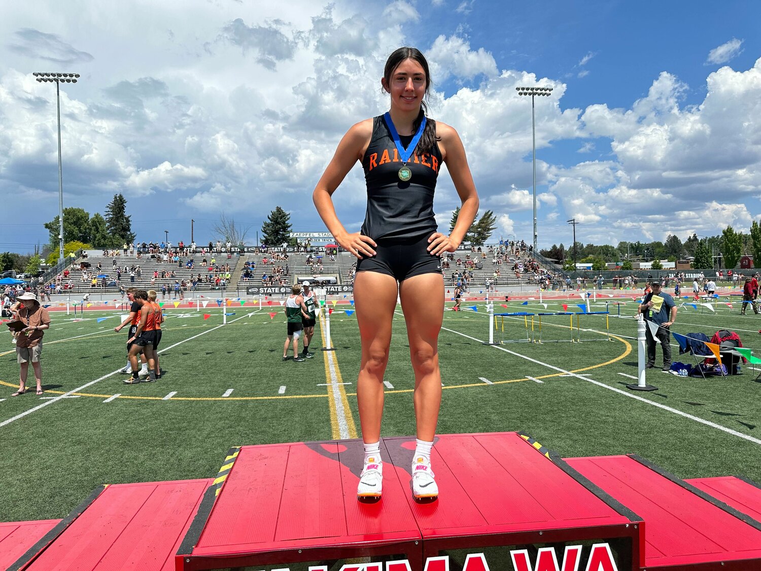 Rainier's Acacia Murphy stands atop the podium after winning the title in the girls high jump at the 2B state track and field championships, May 27 in Yakima.