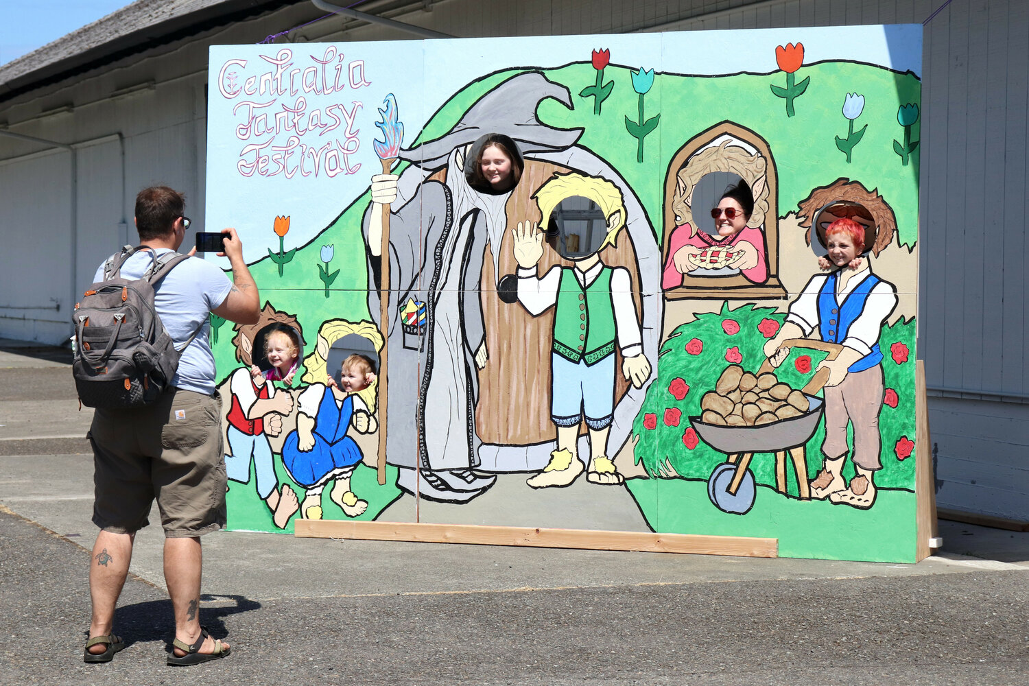 Attendees of the Centralia Fantasy Festival pose for a photo in a photo booth cutout for the festival at the Southwest Washington Fairgrounds on Saturday, May 27.