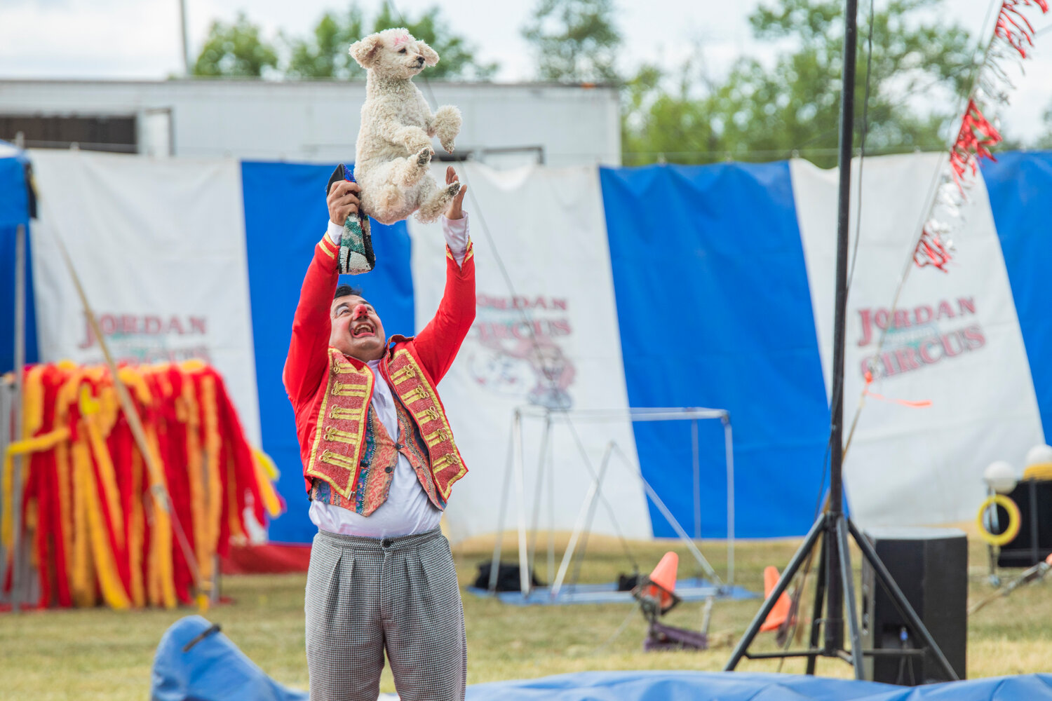 A circus clown tosses a poodle into the air as the crowd cheers at the Southwest Washington Fairgrounds during the Jordan World Circus show on Wednesday, May 31. The circus performed three shows in two days at the fairgrounds this week, with the first being on Tuesday.