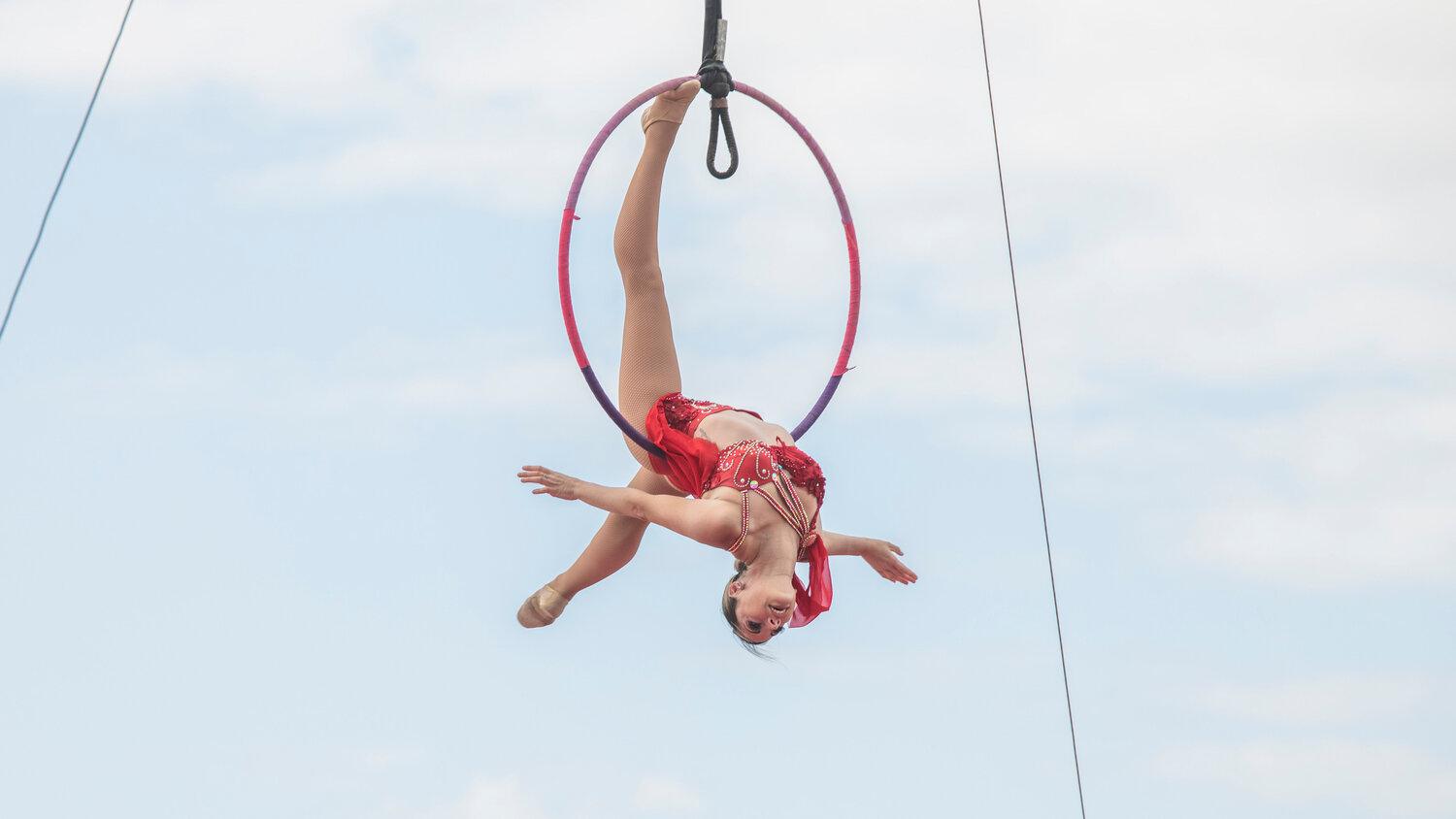 An acrobat hangs from a ring at the Southwest Washington Fairgrounds during the Jordan World Circus show on Wednesday, May 31.