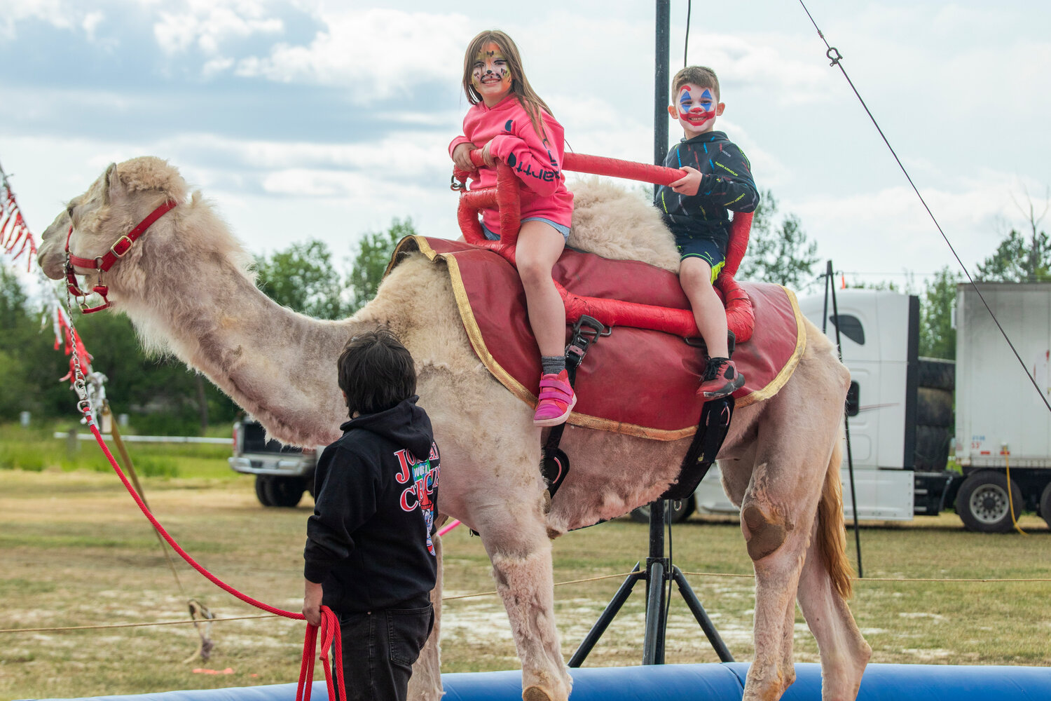 Madilyn Lanning, 9, and her brother Maddox, 6, smile while riding a camel at the Southwest Washington Fairgrounds during the Jordan World Circus show on Wednesday, May 31.