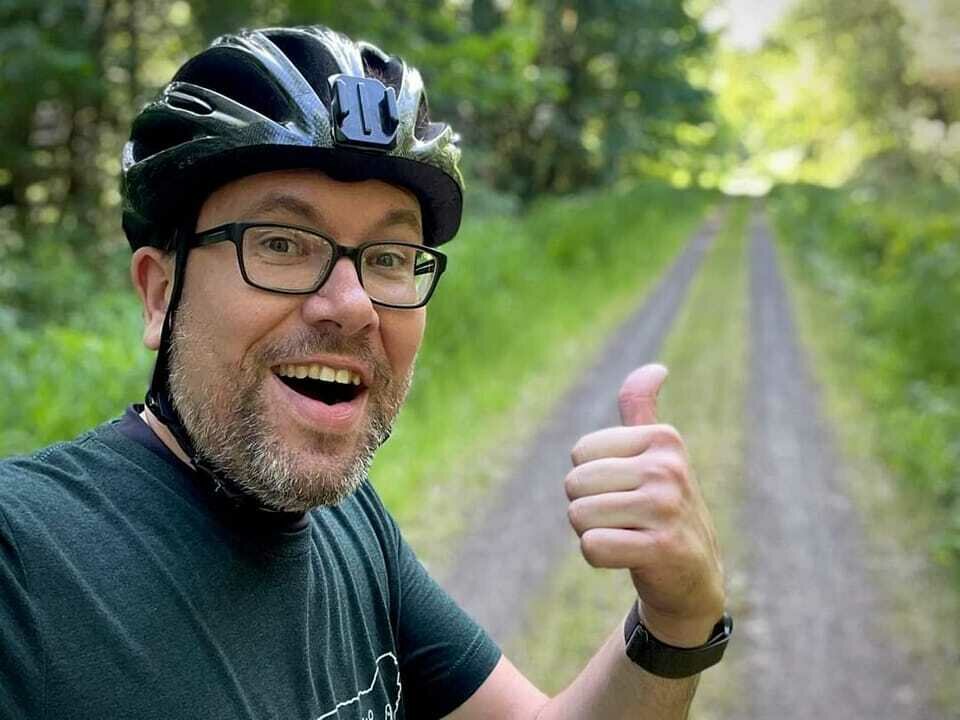 Chris Brewer gives a thumbs up during a recent bike ride on the Willapa Hills Trail.