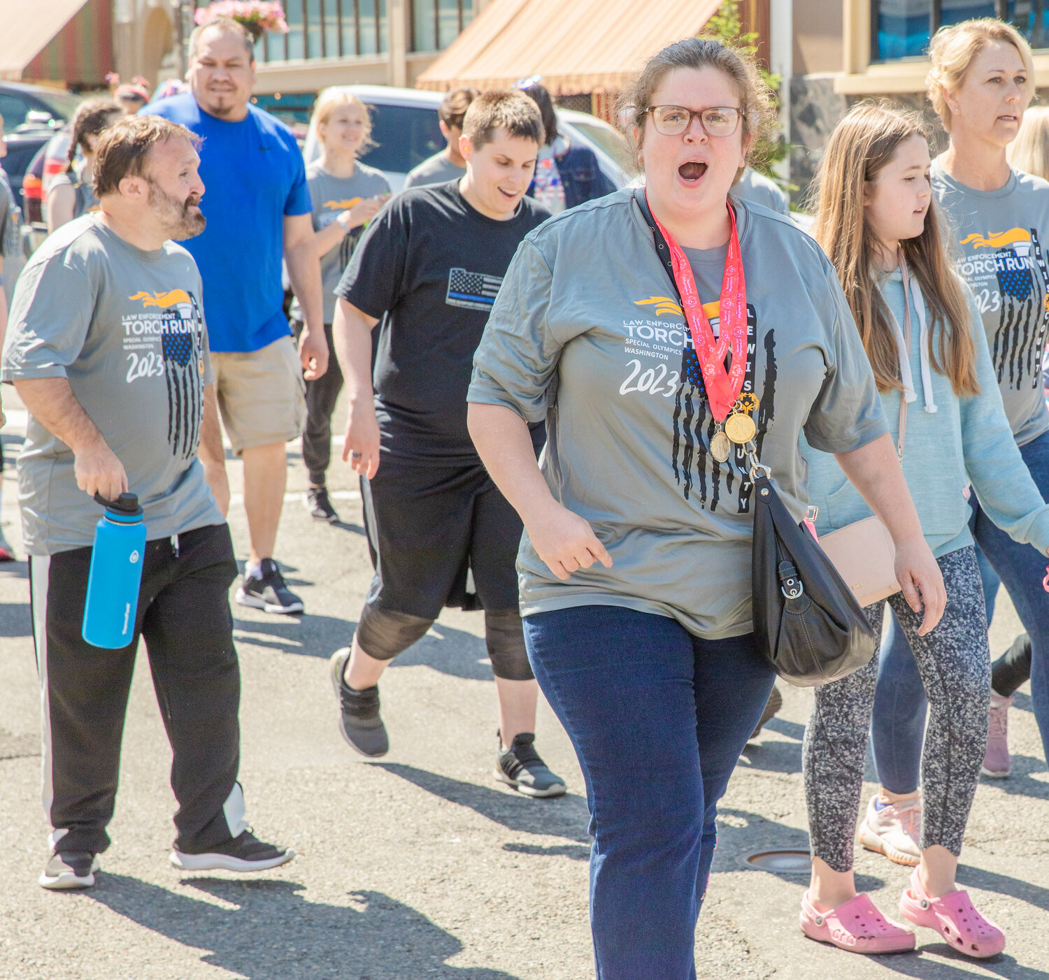 Participants cheer during the Lewis County Special Olympics Law Enforcement Torch Run in downtown Chehalis on Friday, June 2.