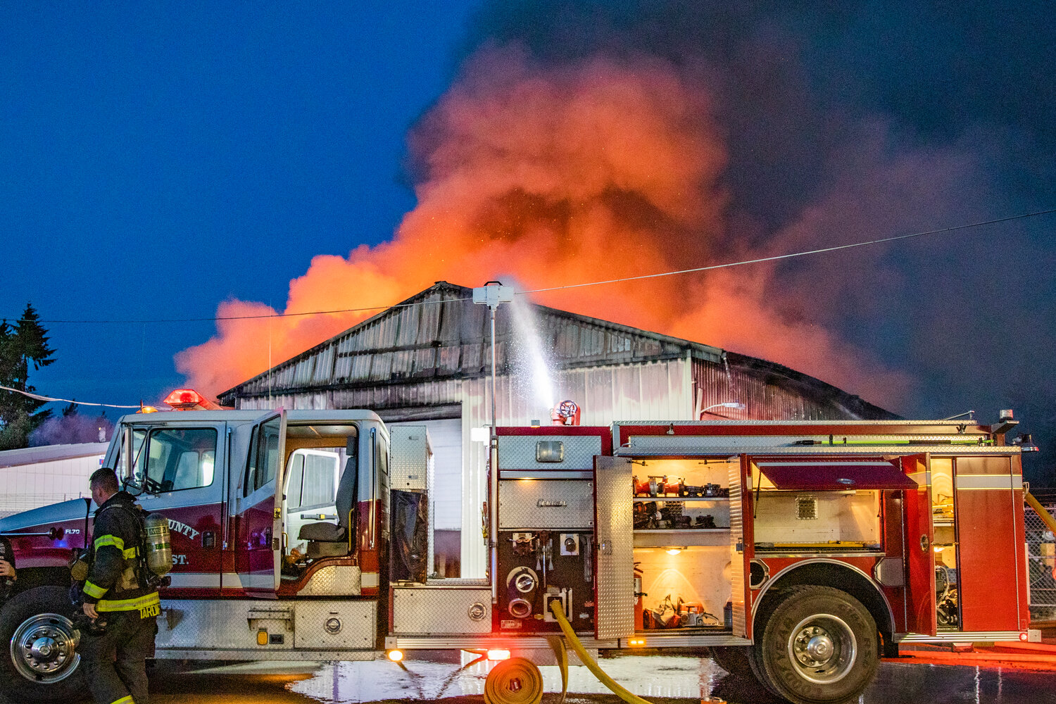 More than five fire and law enforcement agencies respond to douse a large fire in a storage building in downtown Napavine along Alder Avenue Northwest on Saturday, June 3.