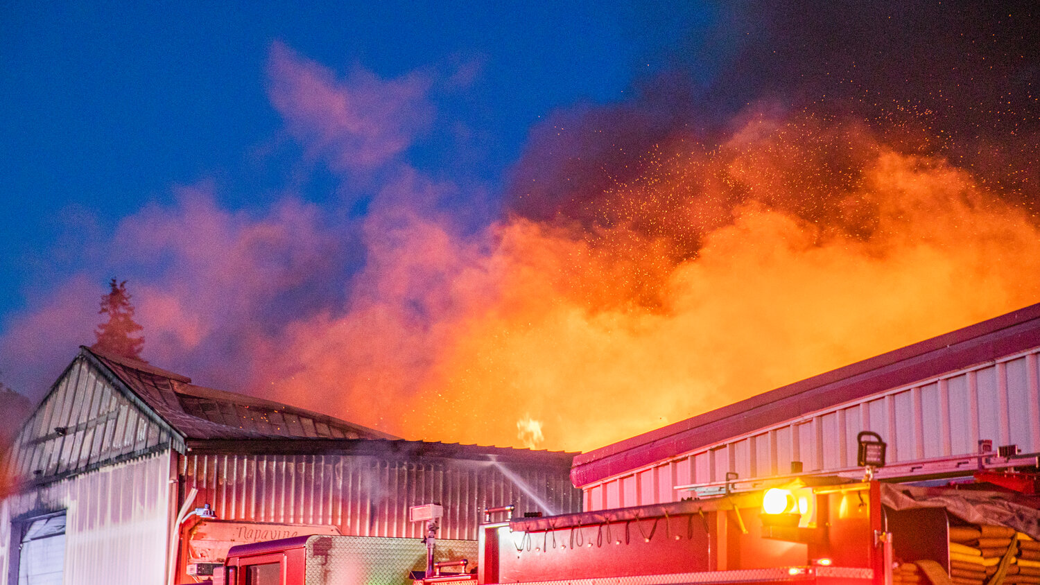 A massive blaze escapes the roof of an aluminum storage building in downtown Napavine on Saturday, June 3.