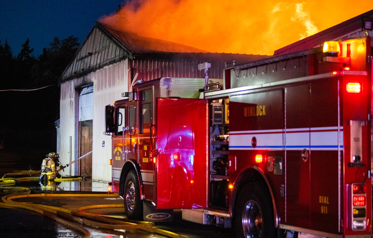 A column of smoke and flames rises from a structure in the 100 Block of Alder Avenue Northwest in Napavine as firefighters respond to the scene on Saturday, June 3.