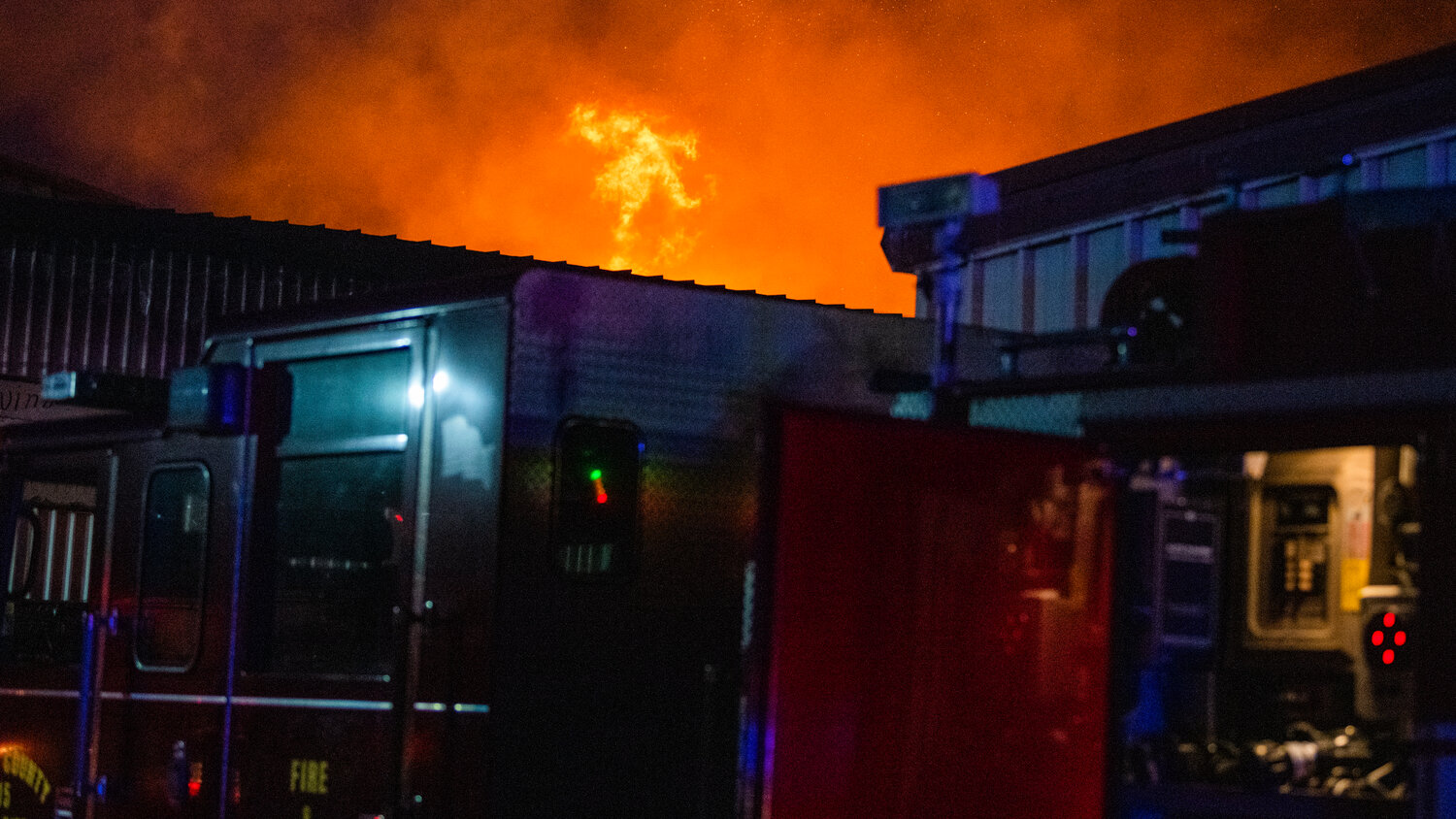 Flames shoot up from a structure in the 100 Block of Alder Avenue Northwest in Napavine as firefighters respond to the scene on Saturday, June 3.