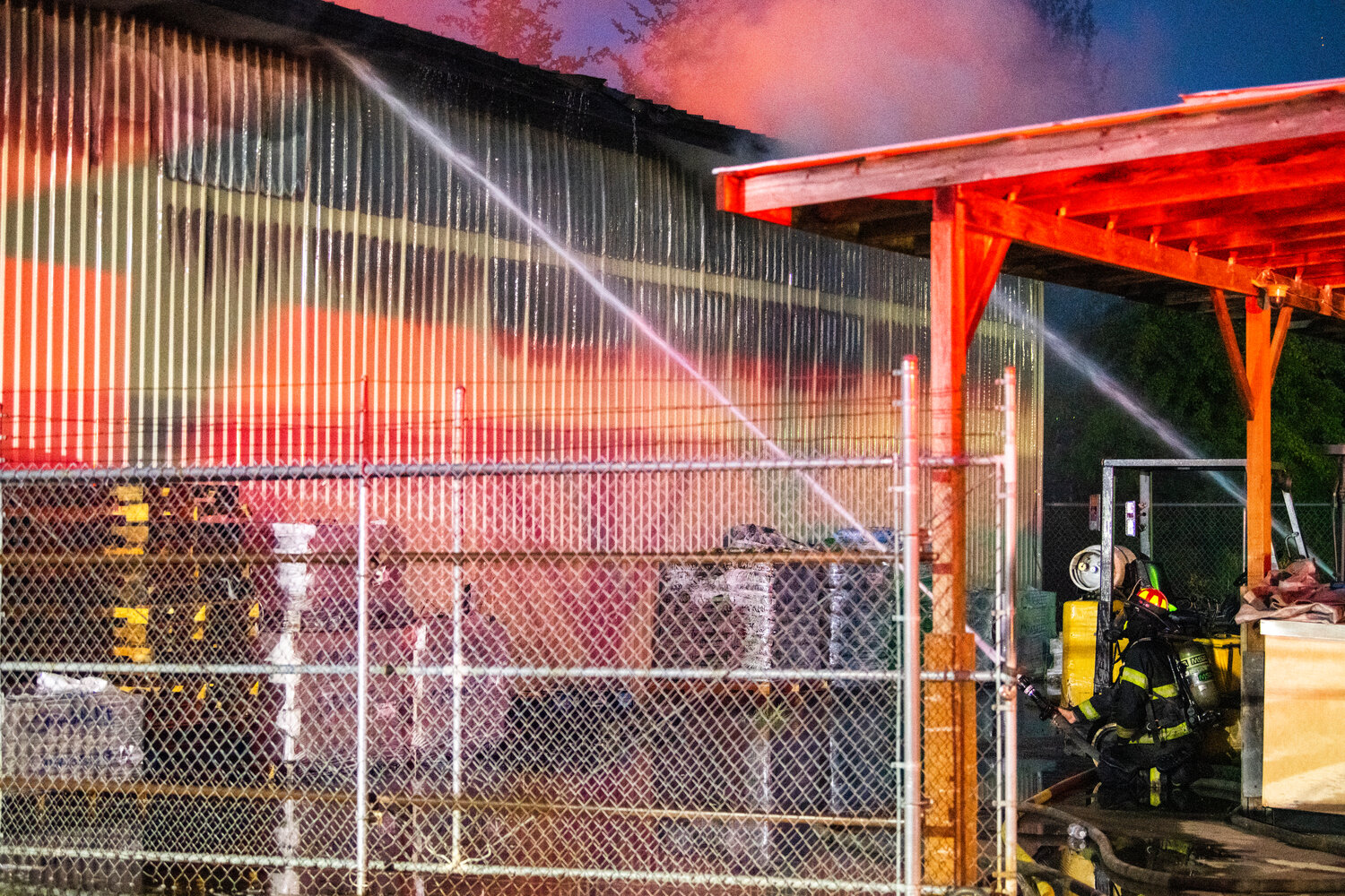 Firefighters battle flames inside a structure in the 100 Block of Alder Avenue Northwest in Napavine on Saturday, June 3.