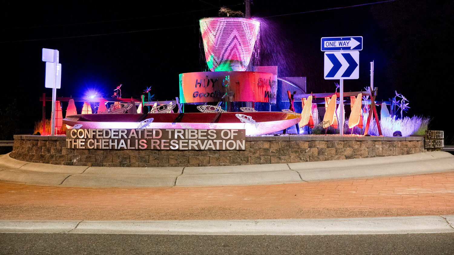 A roundabout decorated with items of significance for the Confederated Tribes of the Chehalis Reservation is illuminated along Anderson Road near Oakville on Friday, July 7.