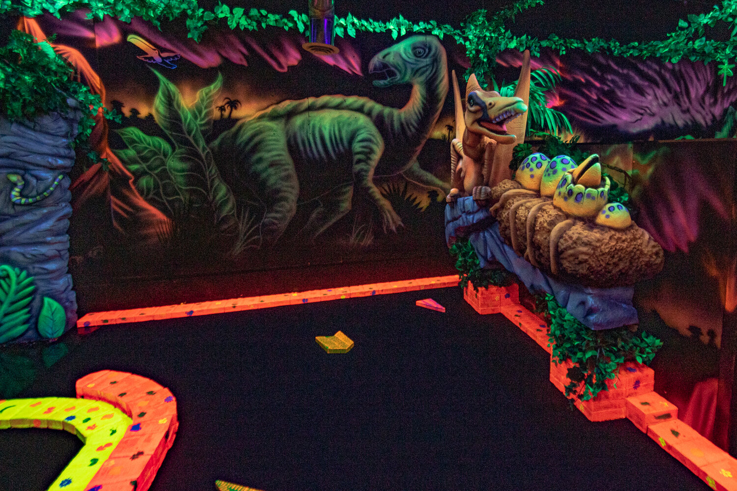 A pterodactyl keeps watch over its nest at the newly reopened Shanks Black Light Miniature Golf in Chehalis.