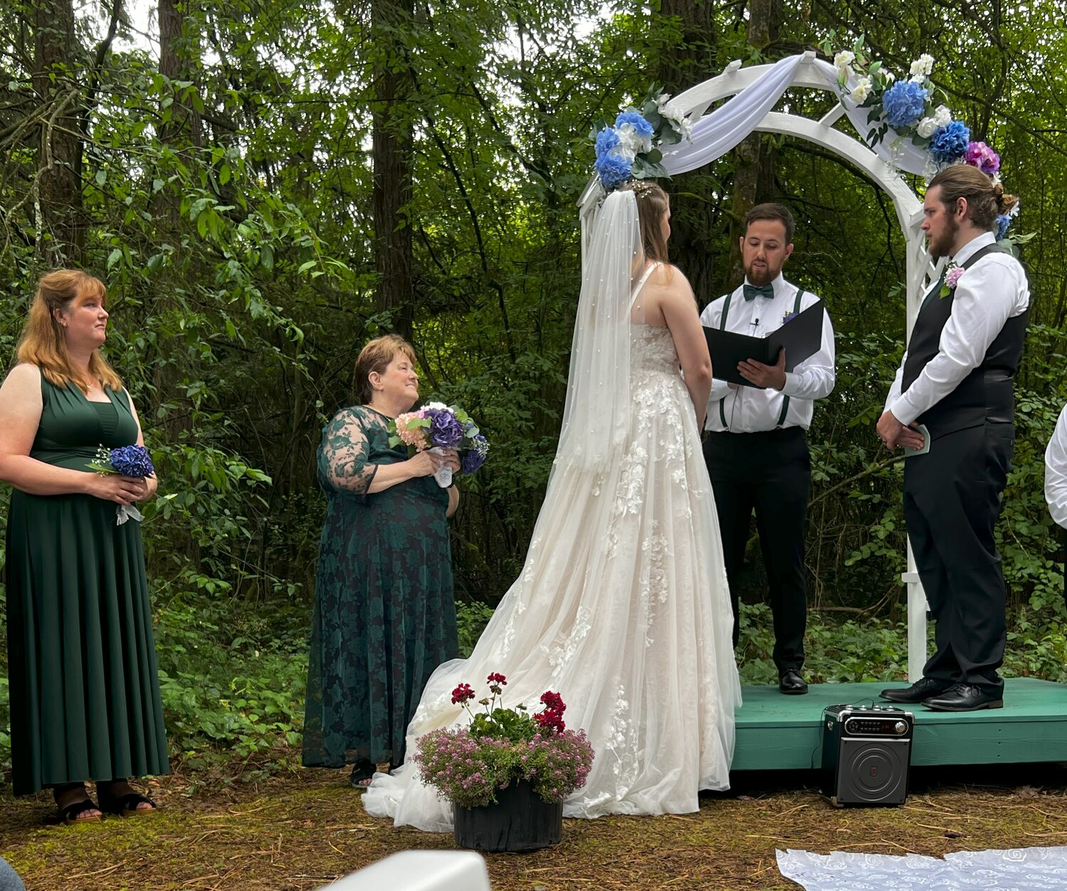 Chronicle columnist Julie McDonald, second from left, looks toward her daughter, Nora, and new son-in-law Chase Conaway during their wedding ceremony in August.