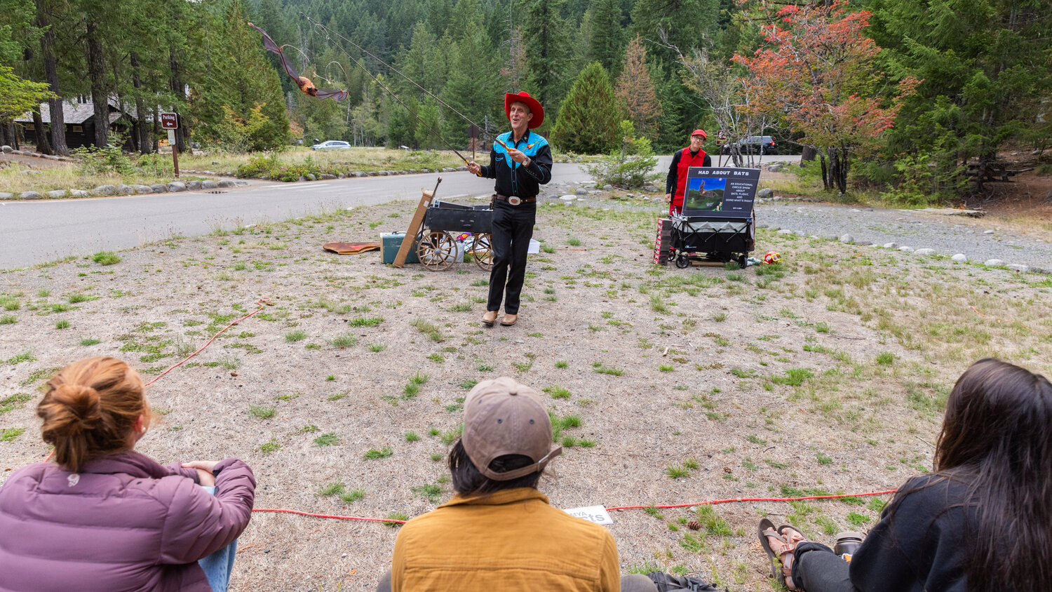 David Lichtenstein smiles while holding a faux bat on fishing wire during a Vaudeville-esque show about the flying mammals at Mount Rainier National Park on Tuesday, Sept. 12.