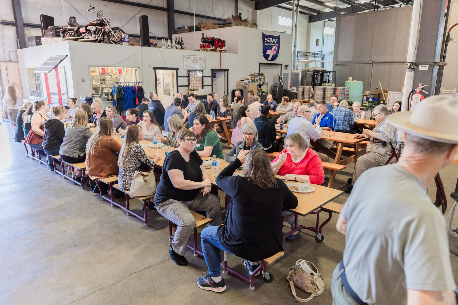 Attendees mingle and munch during the annual member barbecue hosted by the Centralia-Chehalis Chamber of Commerce at Dick’s Brewing on Thursday, Sept. 14, in Centralia. The food was provided by Lucky Eagle Casino and Hotel while the space for the event was provided by Dick’s Brewing.