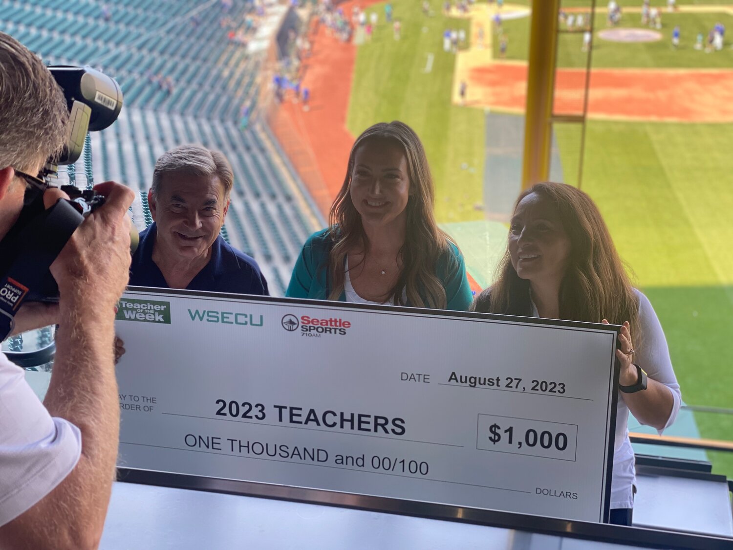 Shaden Beaber, pictured at center, was honored at a Seattle Mariners game on Aug. 27 and received a $1,000 award, $500 of which went to Lintott Elementary School as a classroom grant.