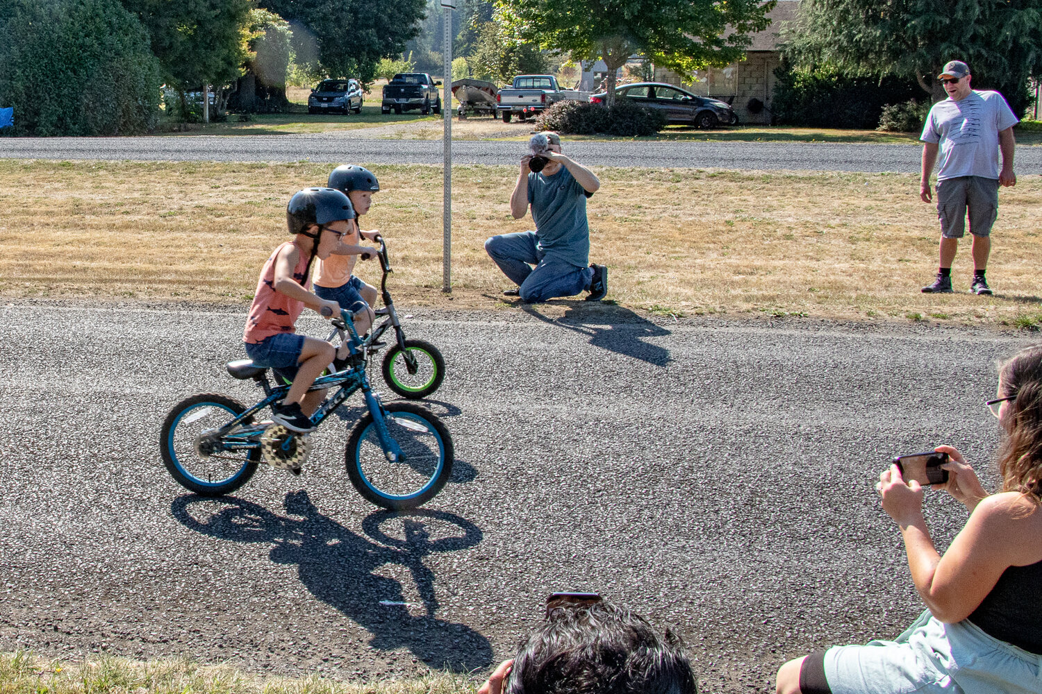 It came down to a photo-finish tie between brothers Leon, on the green-wheeled bike, and Talon Huang, on the blue-wheeled bike, of Mossyrock during the children's bike races at Mossyrock's Mexican Independence Day celebration on Saturday, Sept. 16.