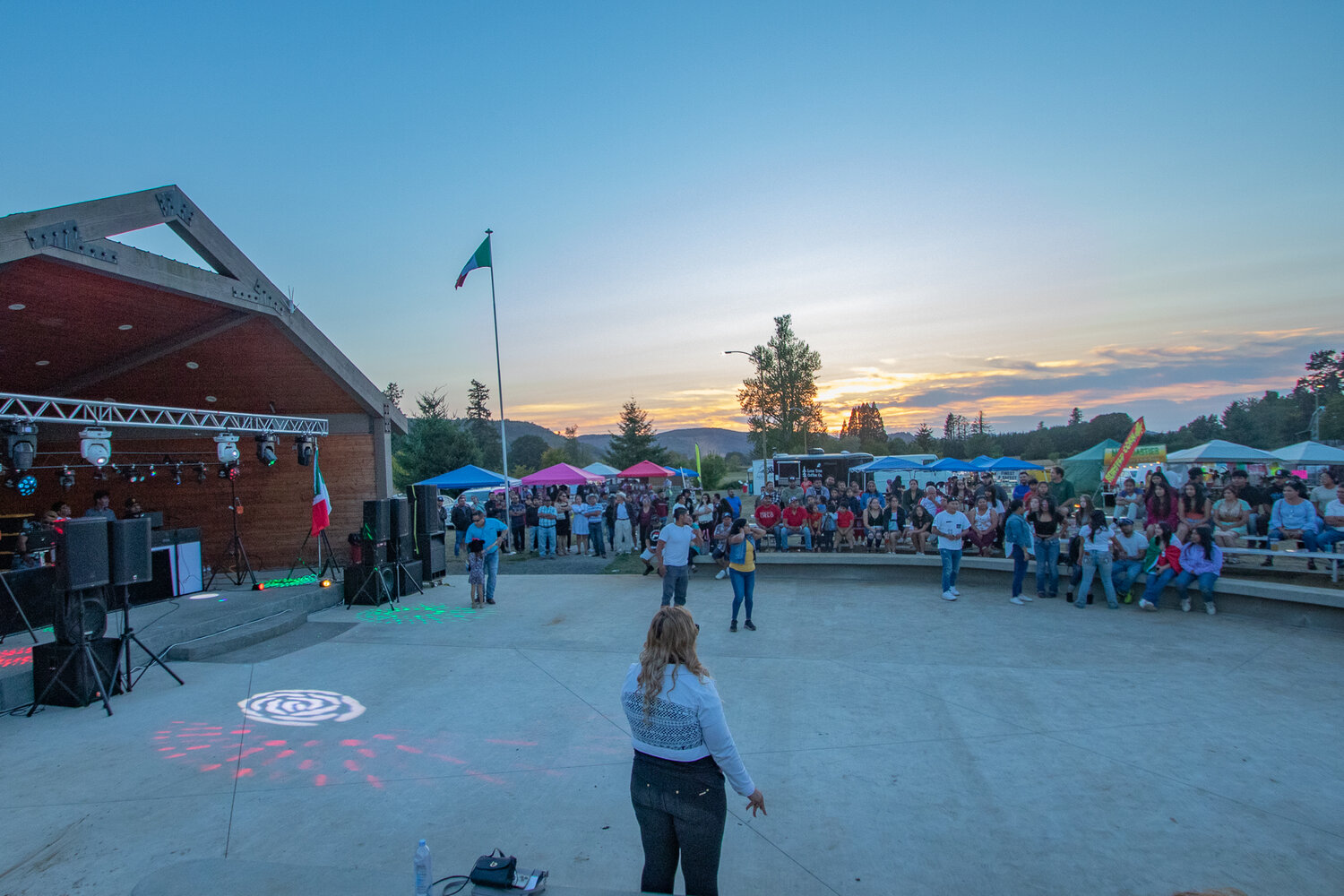 Dancers begin to make their way out in front of the amphitheater at Klickitat Prairie Park in Mossyrock as DJ Escandalo Zona Orienta began playing music as the sun went down during the Mexican Independence Day celebration on Saturday, Sept. 16.