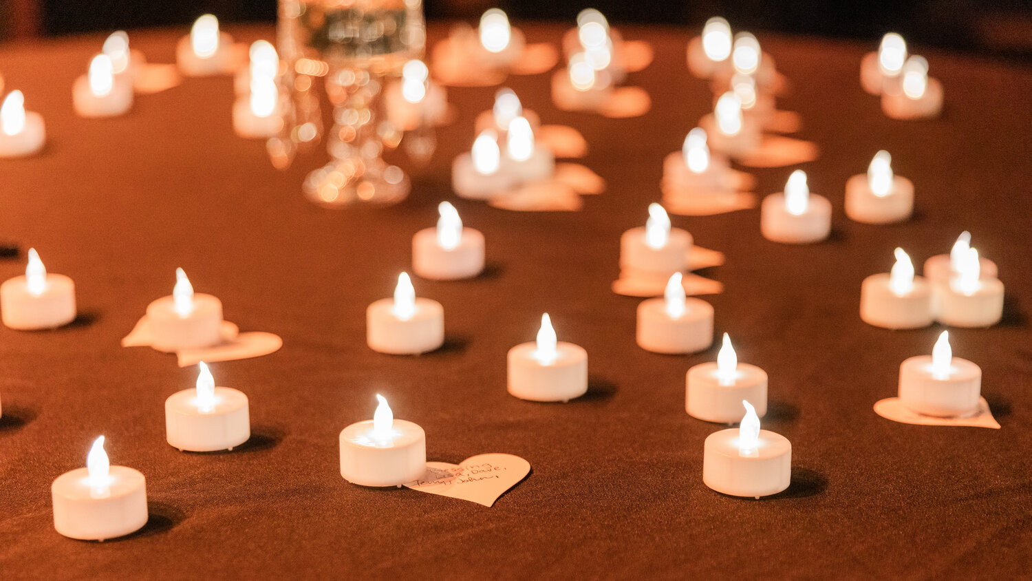 Tea lights are illuminated over heart-shaped notes during a showing of “Love in the Time of Fentanyl” at McFiler’s Chehalis Theater on Monday, Sept. 18.