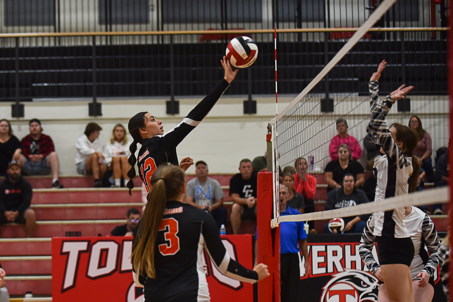 Acacia Murphy tips the ball over the net during Rainier's victory over Toledo on Sept. 19.