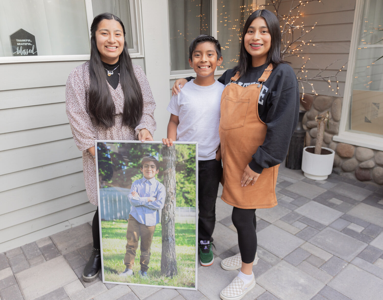 Isaac Flores smiles for a photo with his siblings at his Centralia residence on Thursday, Sept. 21.