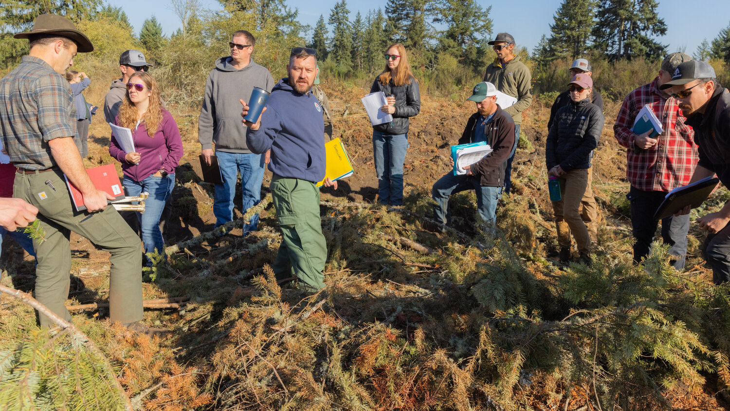 Certified Burner Program Manager Kyle Lapham, with the Department of Natural Resources, leads a training on prescribed burning at West Rocky Prairie near Tenino on Thursday, Sept. 21.