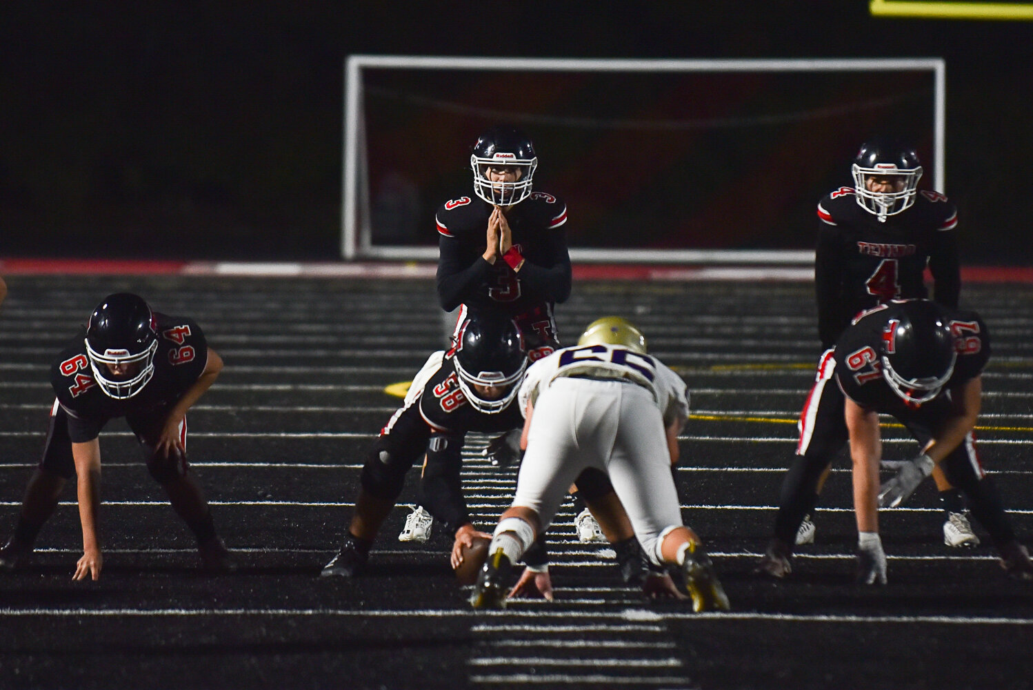 Tenino's Cody Strawn reads the Ony defense pre-snap during a 62-21 loss on Sept. 22.