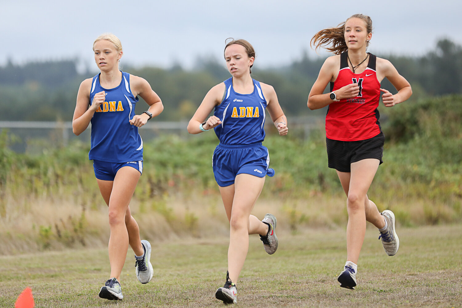 Adna's Megan Price (left) and Megan Stout (center) and Mossyrock's Joan Wedam (right) run at a Central 2B League meet at Adna on Sept. 28.