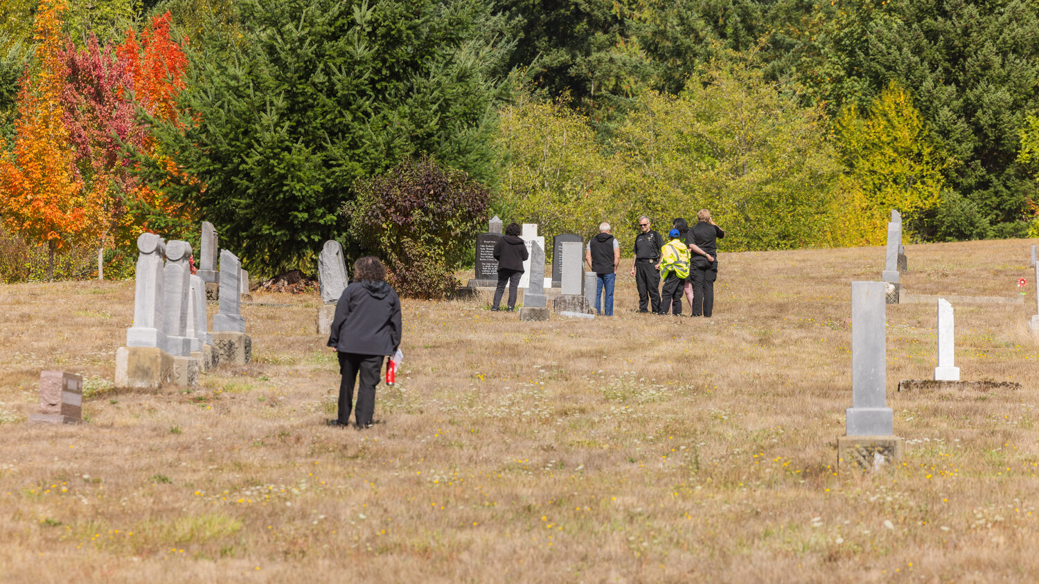 Attendees visit gravesites during a ceremony in Chehalis honoring unclaimed remains on Thursday, Sept. 28.