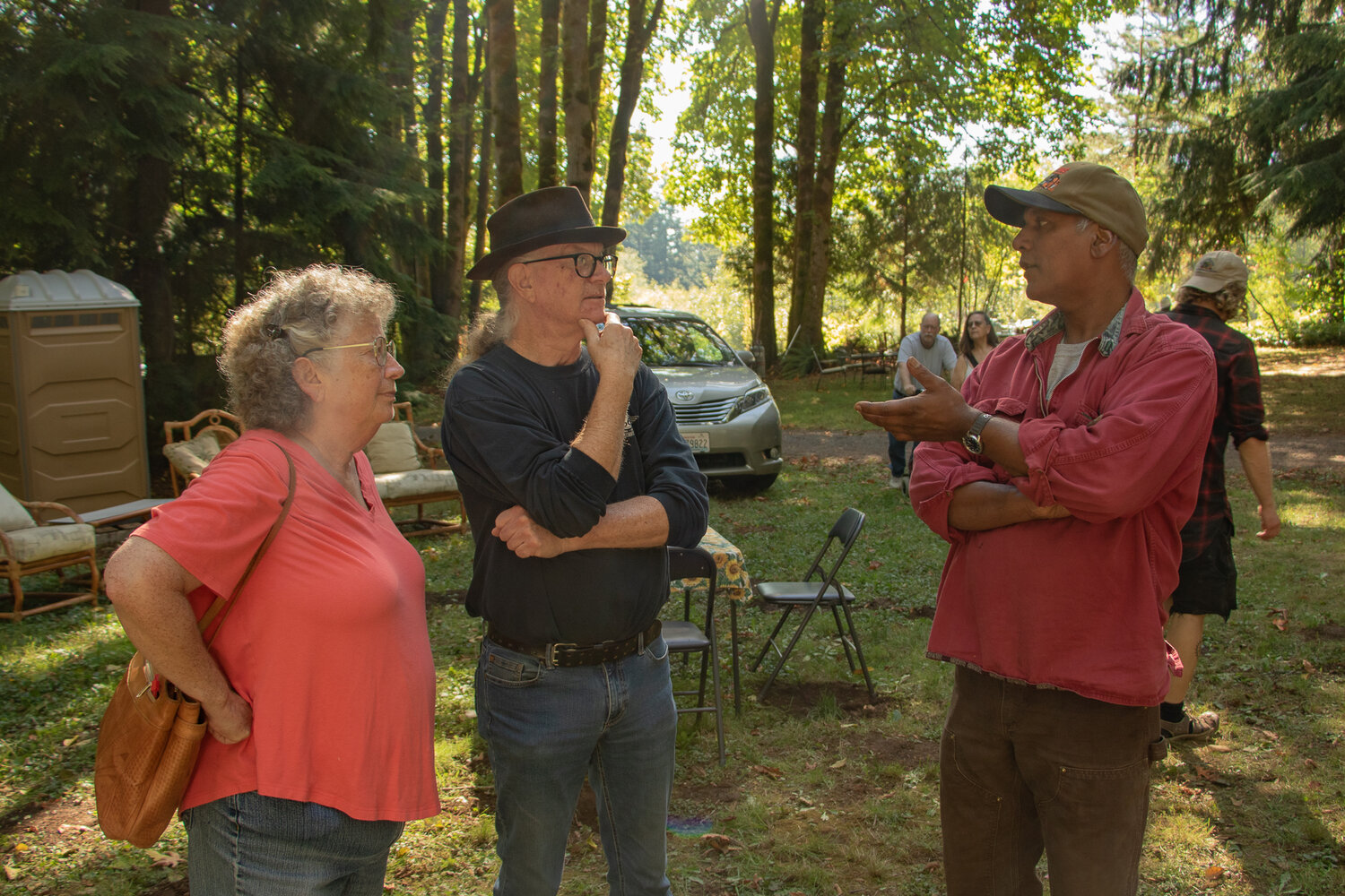 Harry Bhagwandin, left, talks to visitors on Sunday, Oct. 8, at Shady Grove Orchards, a farm he owns dedicated to growing nut-producing trees.