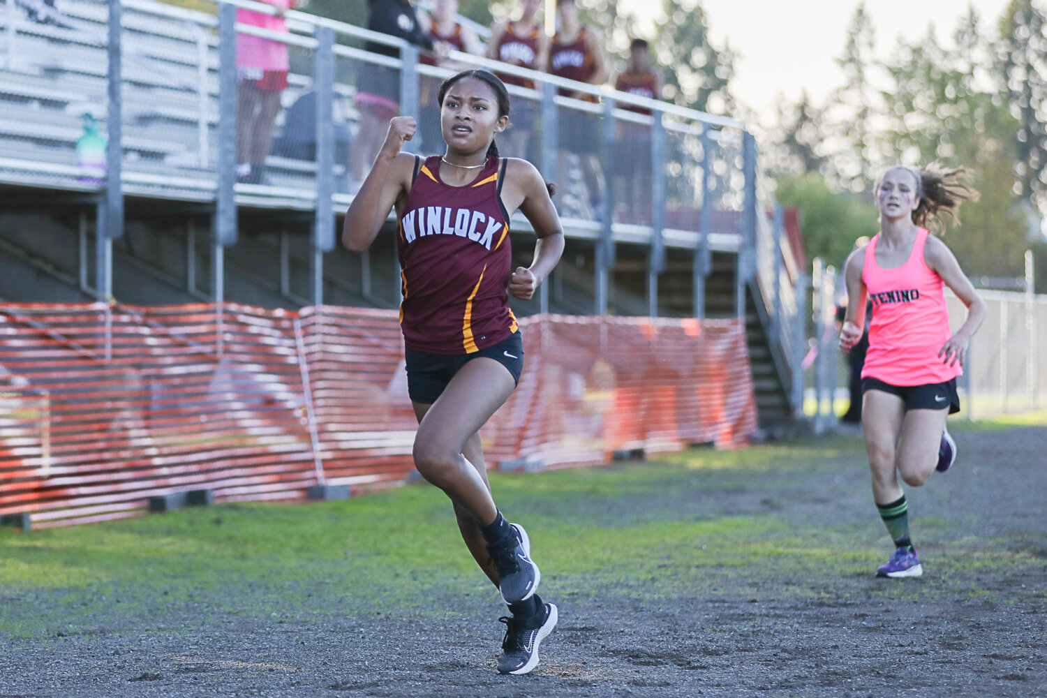 Winlock's Victoria Sancho beats Tenino's Samantha Smith in a sprint for second place at a cross country meet at Winlock on Oct. 12.