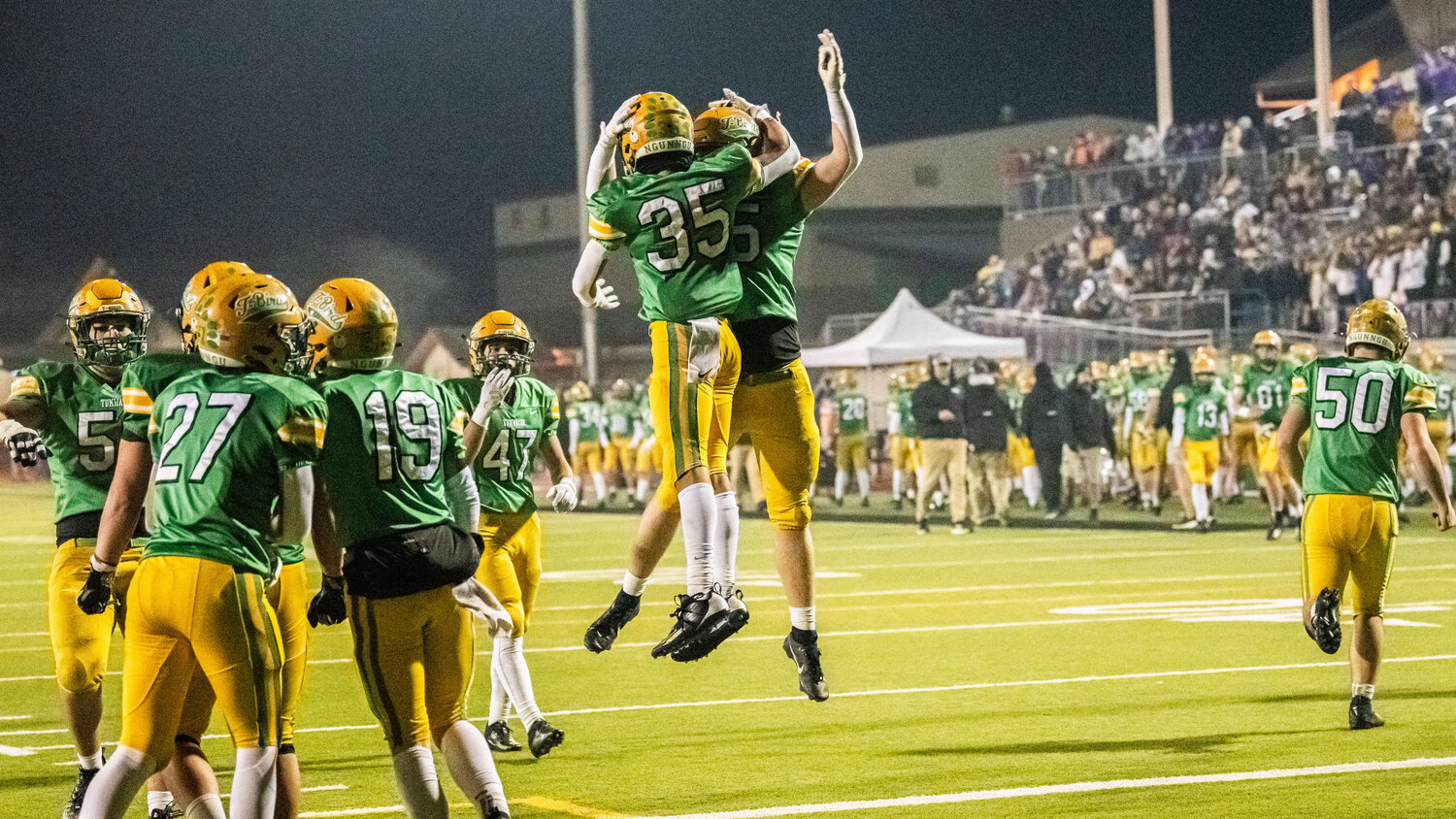 Tumwater celebrates after Kooper Clark (35) scores a touchdown for the Thunderbirds in a 2A state semifinal game against North Kitsap on Saturday night.